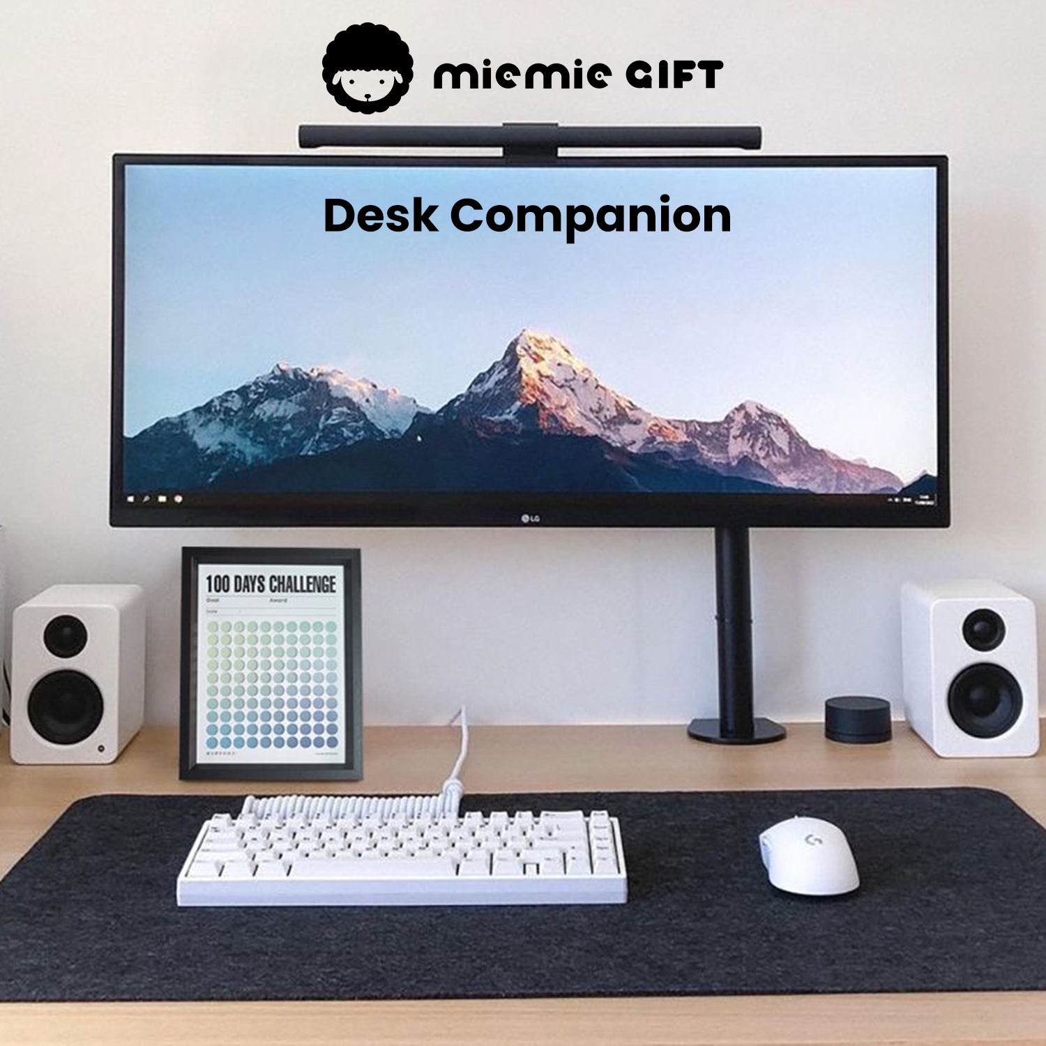 A modern and minimalist desk setup featuring a widescreen monitor with a mountain view, white keyboard, and mouse, accompanied by a black-framed 100 Days Challenge Frame in Fresh Green gradient design. Ideal for keeping motivation and productivity at the forefront of your workspace.