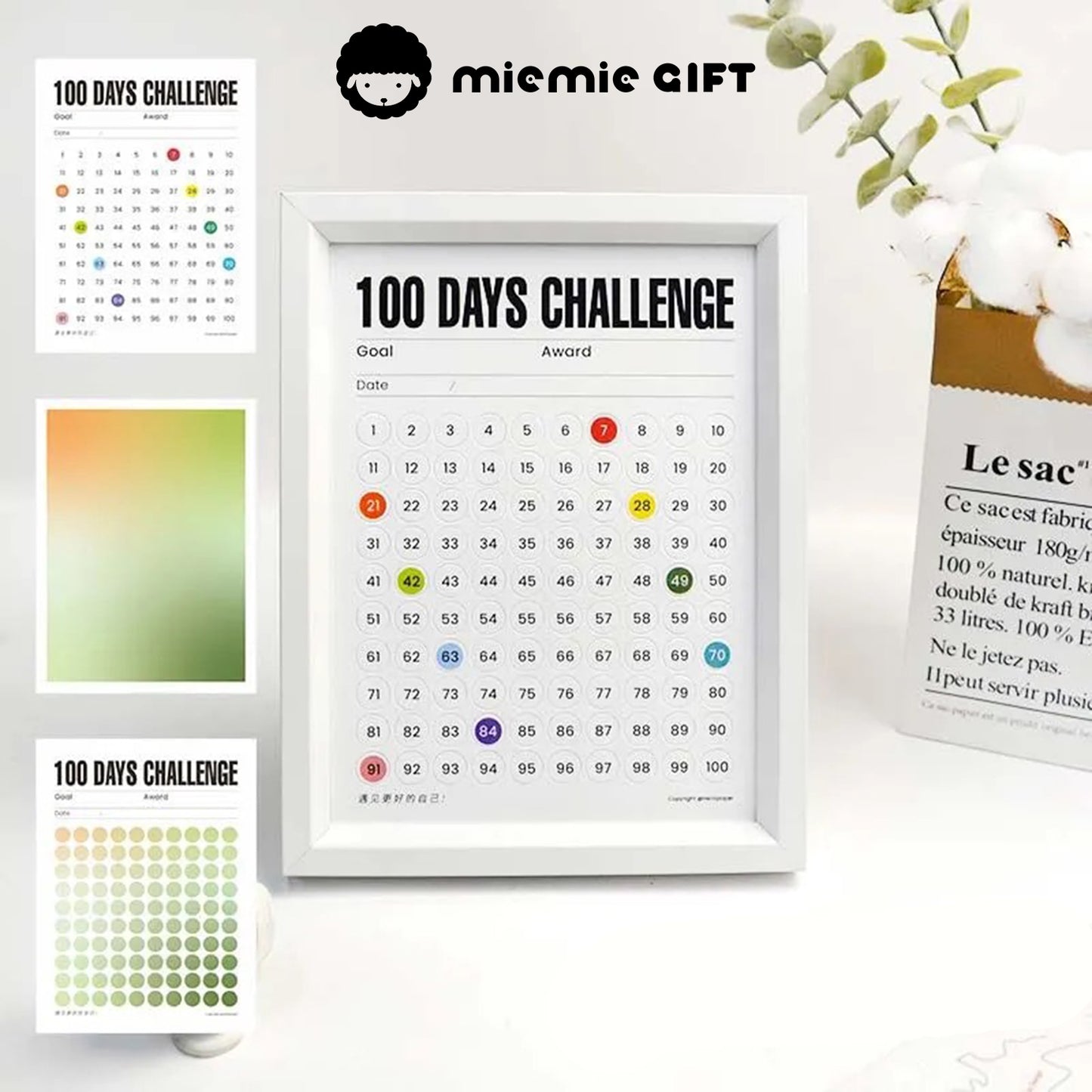 A close-up of the 100 Days Challenge Frame with a white border, featuring vibrant gradient designs and goal-tracking options. The image includes additional gradient paper options and a cotton branch in a minimalist vase, showcasing its versatility as both a motivational tool and a decorative piece.