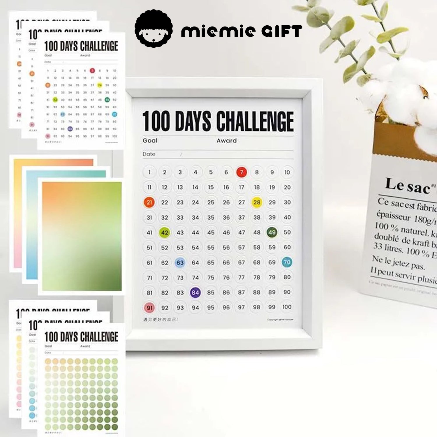 A white-framed 100 Days Challenge tracker with multiple vibrant gradient paper options, including warm, green, and blue tones. This image showcases the customizable design, perfect for goal setting and adding a stylish touch to any space.