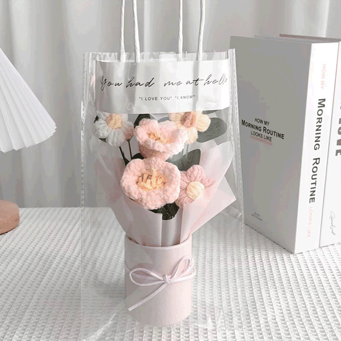 Sunny pink lily of the valley crochet bouquet complemented by white daisies in a pink flower bucket in gift bag