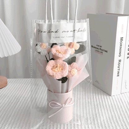 Sunny pink lily of the valley crochet bouquet complemented by white daisies in a pink flower bucket in gift bag