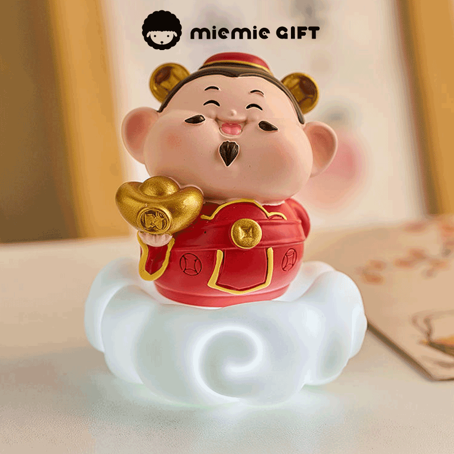 Wealth's Divine Messenger Figurine: A mini Caishen statue, the god of wealth, with a gold ingot in hand, seated on a cloud, a symbol of the divine's influence over prosperity and financial gain placing on desk