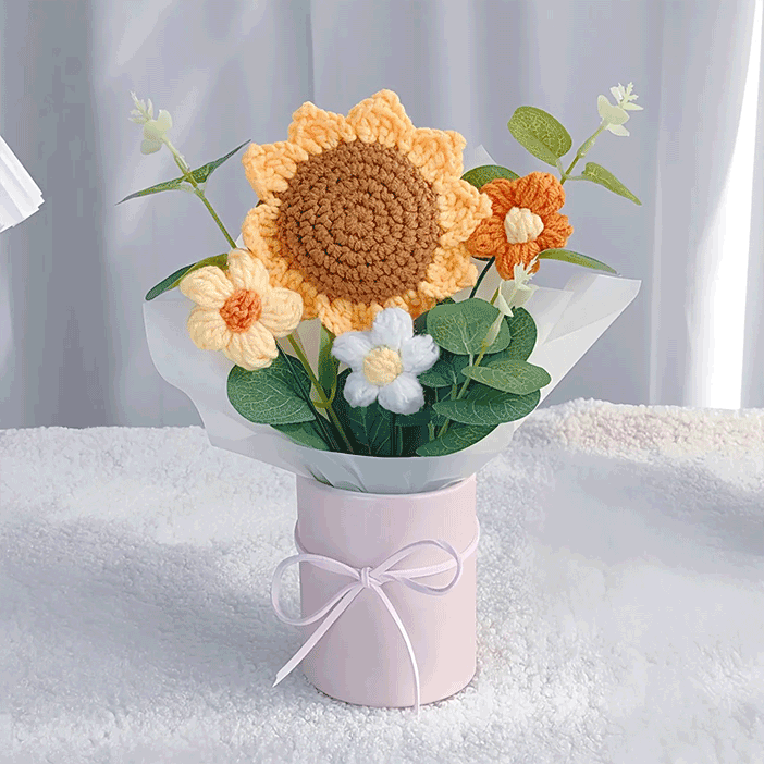 Knitted sunflower in Pink Pot: A sunflower center piece hand-knitted with love resting in a pink pot with a matching ribbon