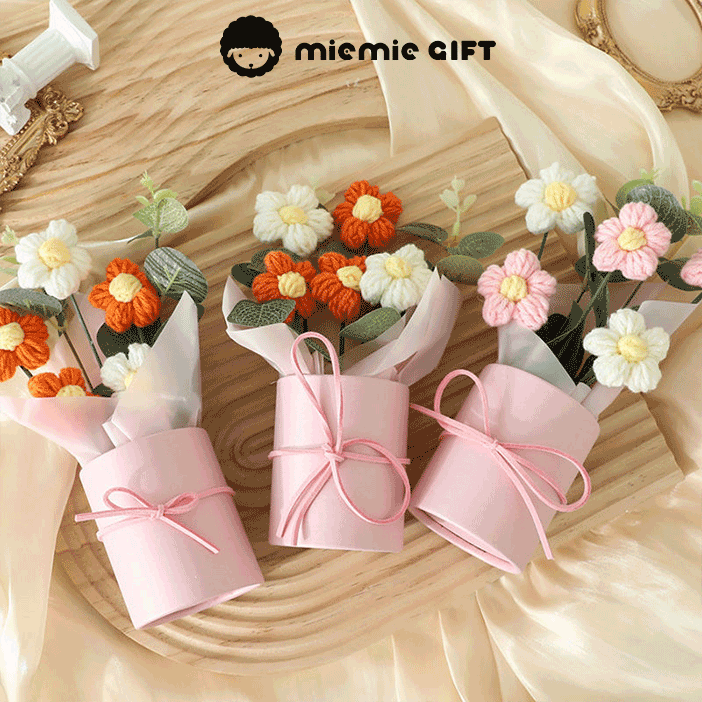 Handmade Daisy Color Palette A bouquet of hand-knitted daisies in a range of colors symbolizing diversity and beauty in pink boxes with ribbons