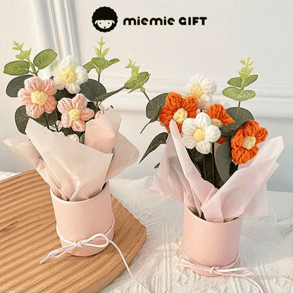 Knitted Daisy Rainbow A bouquet of hand-knitted daisies in a rainbow of colors, a symbol of joy and positivity presented in a pink box with a ribbon