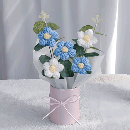 Hand-knitted blue Daisy Delight A bouquet of hand-knitted daisies a gift that blooms with love, elegantly arranged in a pink bucket with a bow