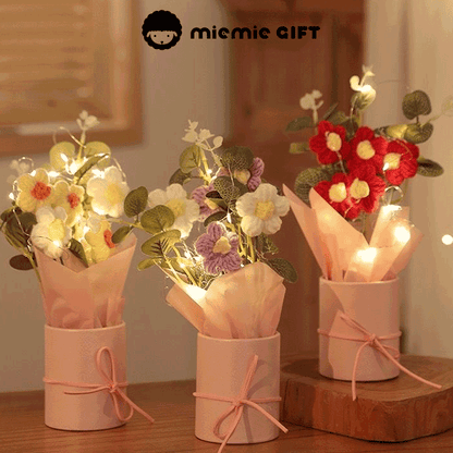 Knitted Daisy Serenity A bouquet of hand-knitted daisies a symbol of simplicity and grace arranged in a pink box with a bow and adorned with fairy lights for a touch of magic