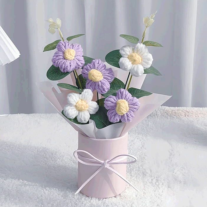Crocheted purle Daisy Elegance A hand-knitted bouquet of daisies a testament to the beauty of handcraft tied with a pink ribbon