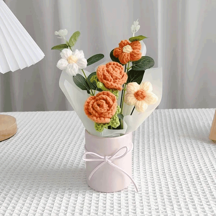 Handmadeorange rose Bouquet A bouquet of hand-knitted rose each one a testament to the art of crochet in a pink pot