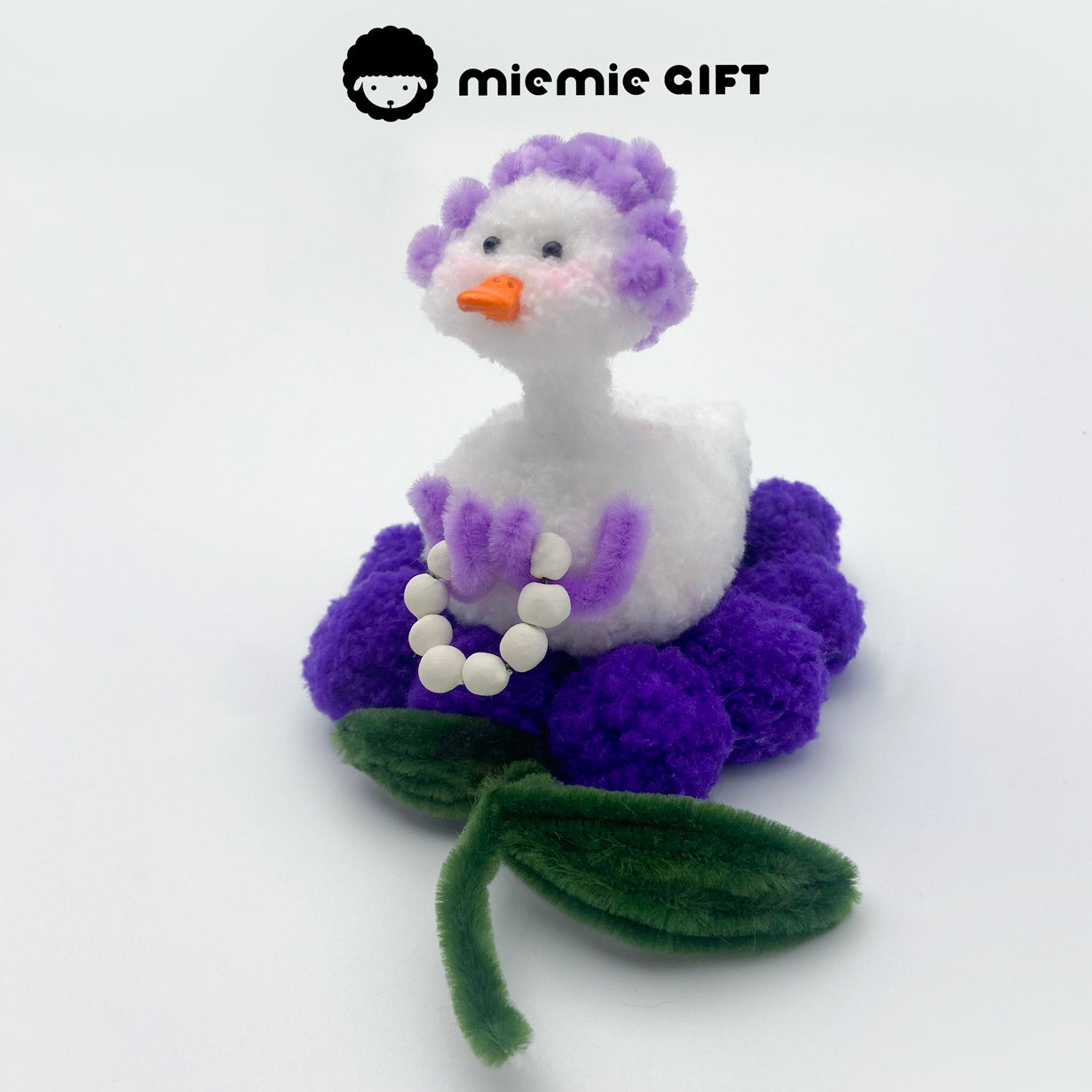 A handmade grape-themed duck doll with bouncy soft texture, part of miemie gift’s fruity duck lineup.