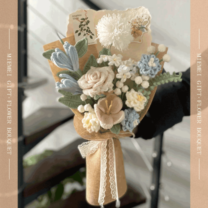 White knitted flower featuring blue lily rose Taraxacum arrangement wrapped in beige paper with a blue accent