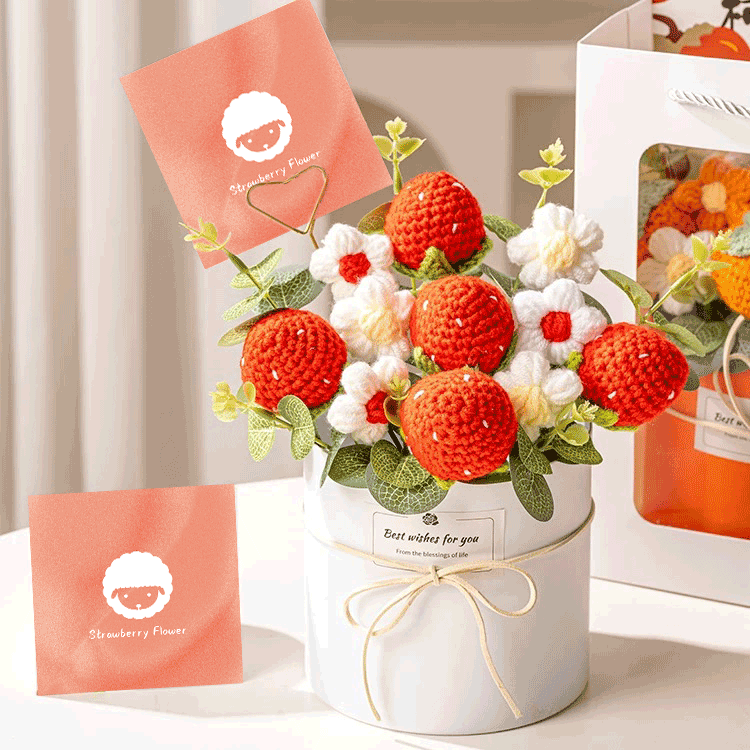 Artisan Peach Blossom Bouquet A hand-knitted bouquet featuring intricately crafted strawberry nestled in a white box with a strawberry flower' card and a cream ribbon