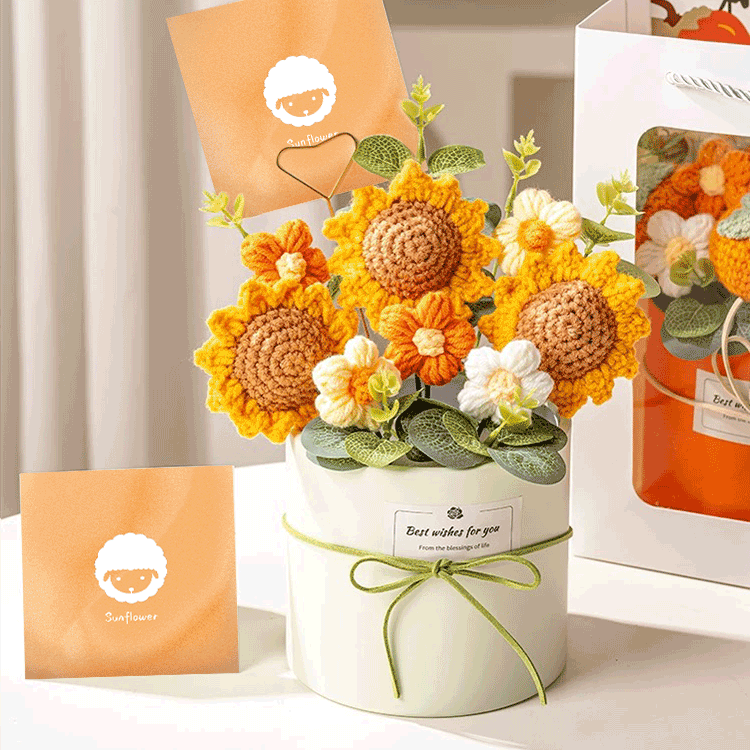 Knitted Peach Blossom Arrangement A bouquet of hand-knitted sunflower a unique and charming gift elegantly packed in a pink box with a green ribbon