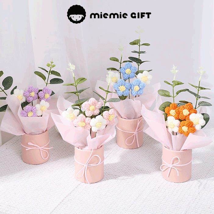 Hand-knitted Daisy Colorful Arrangement A bouquet of hand-knitted daisies in a colorful display, a gift of warmth and creativity in a pink box with a ribbon