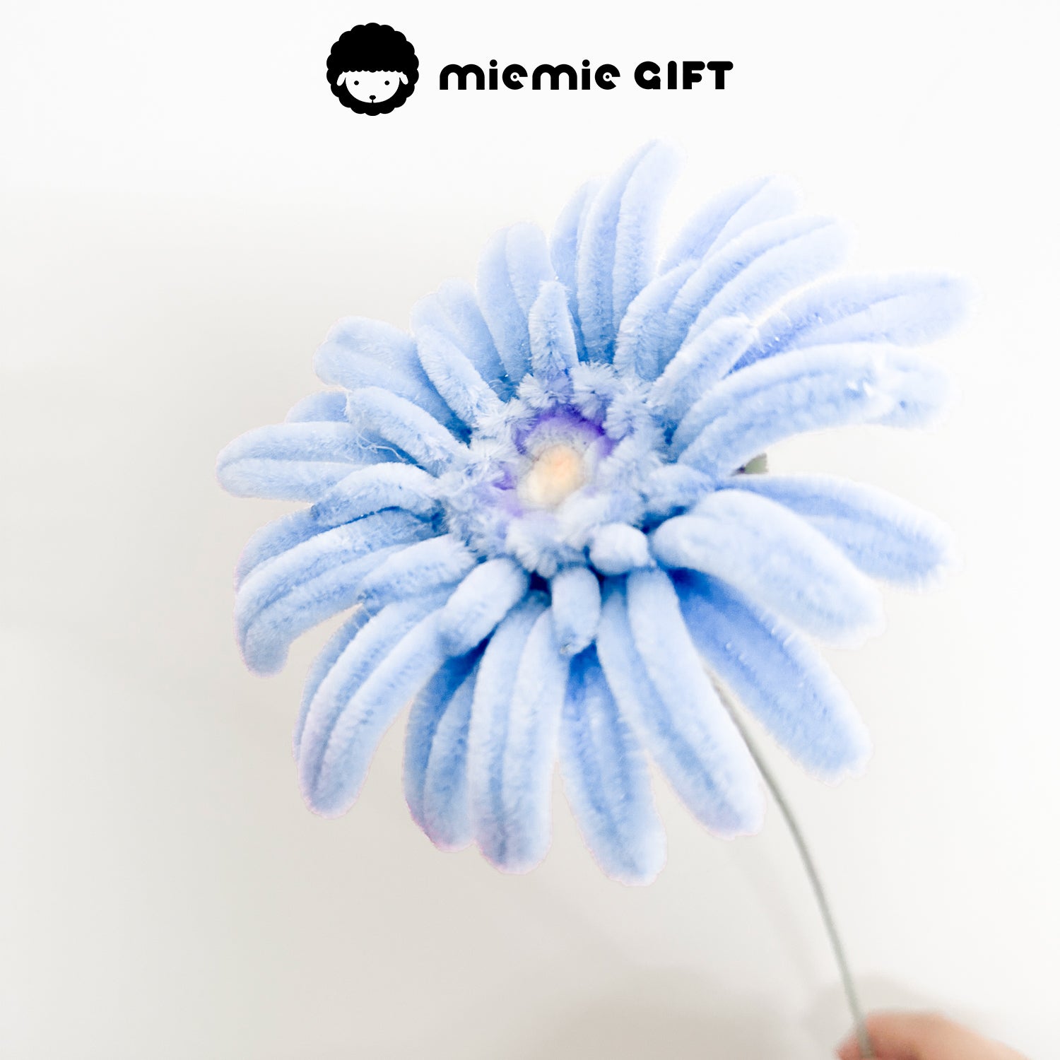 Handmade light blue frangipani flower crafted with pipe cleaners by MieMie Gift, perfect for DIY crafts and home decor.