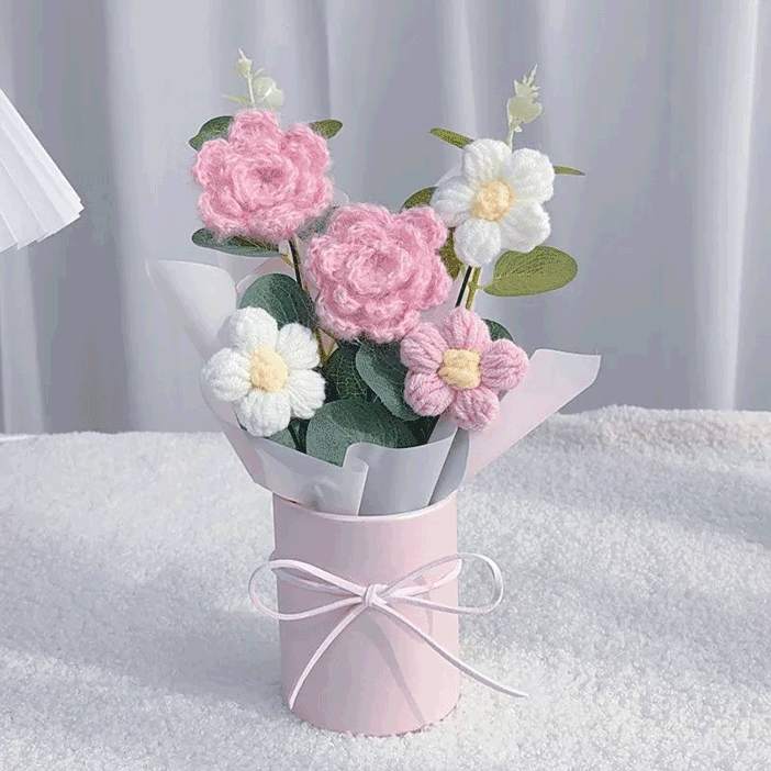 Crocheted Camellia with Ribbon A single hand-knitted pink Camellia wrapped in white paper and tied with a pink ribbon ready for gifting