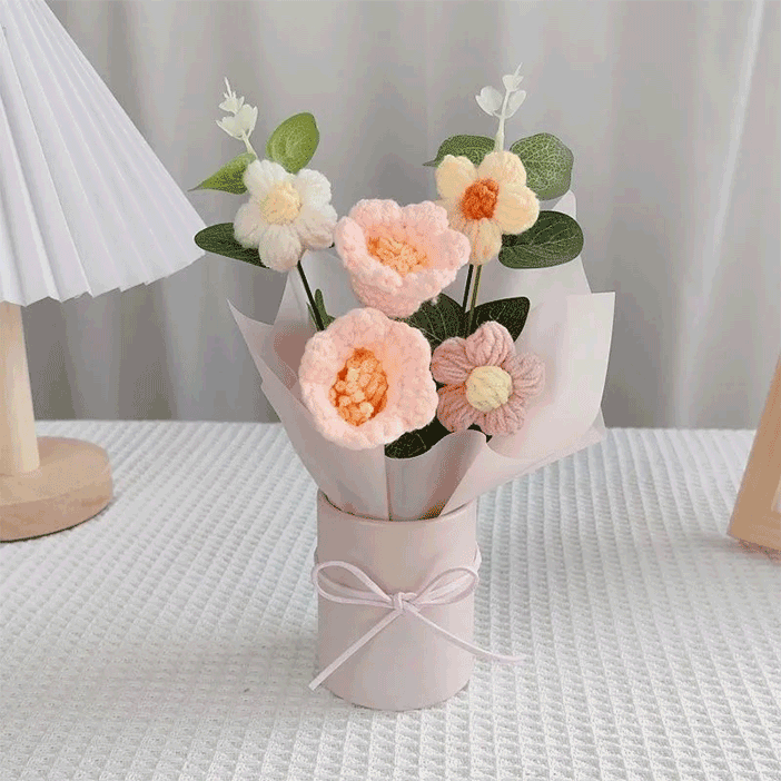 Hand-knitted lily of the valley Bouquet A charming collection of crocheted daisies in a pink pot adorned with a delicate pink ribbon