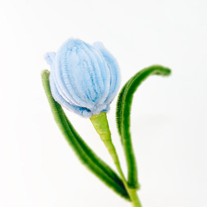 Soft pastel blue tulip made from pipe cleaners, a charming handmade floral piece.