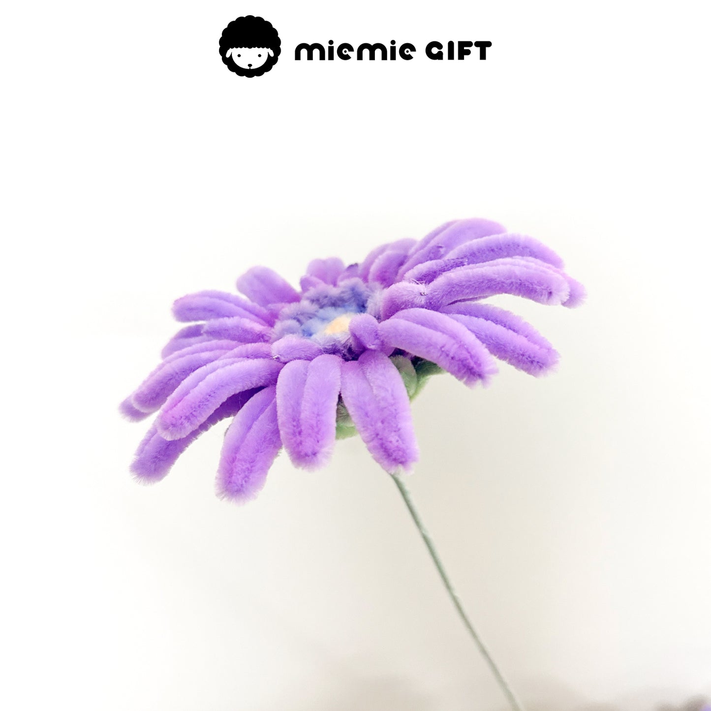  Side perspective of a handcrafted purple frangipani flower made from pipe cleaners, ideal for DIY projects and creative decor.