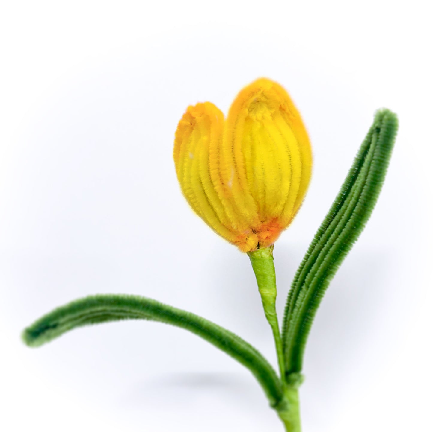 Bright yellow tulip flower made from pipe cleaners, bringing warmth to any space.