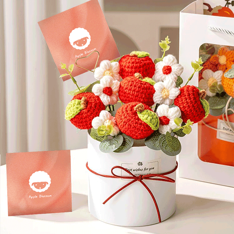 Crochet Peach Blossom Bouquet A hand-knitted bouquet of apple blossom a symbol of love and beauty beautifully arranged in a white box with a heart-shaped card.