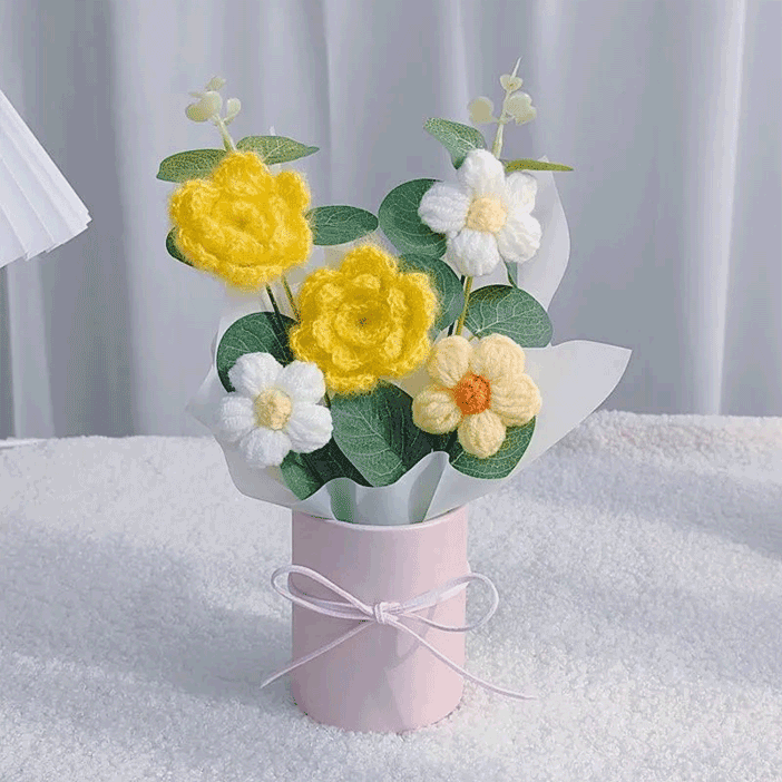 Crocheted Daisy Arrangement A bouquet of hand-knitted yellow camellia symbolizing ternal love, loyal friendship presented in a pink bucket