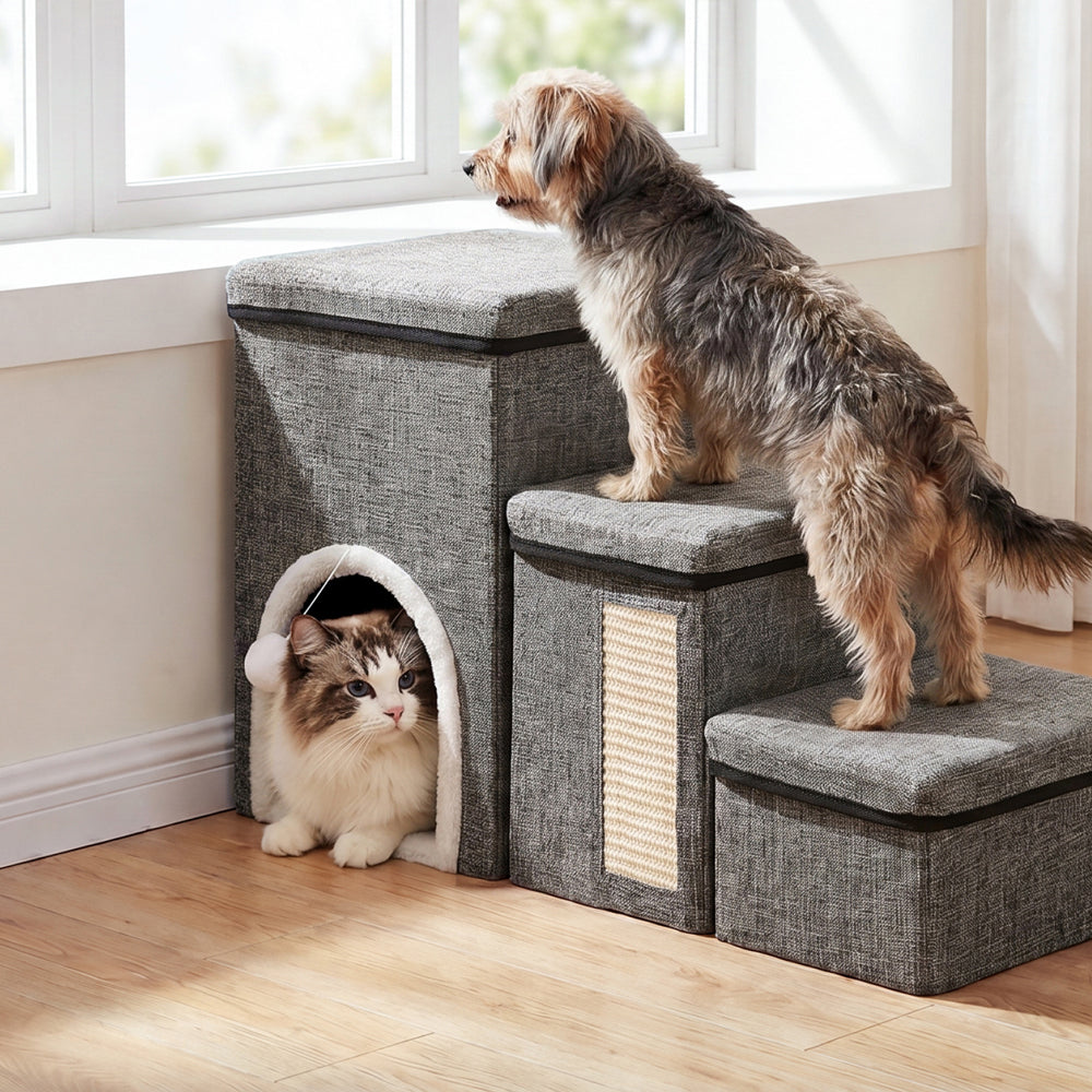 Foldable pet stairs by a window with a small dog climbing the steps and a cat resting in the cozy hideaway.