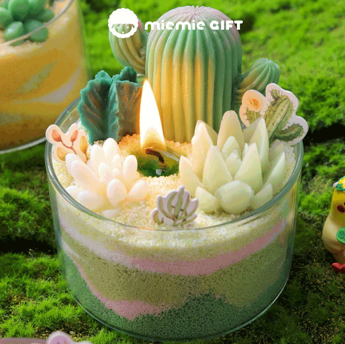 Mini succulent garden-inspired candle in a glass cup sand art candle craft A lit wick in the center emits a warm, cozy glow, enhancing the overall aesthetic