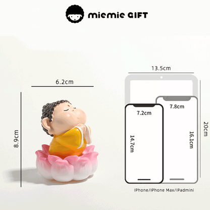 Miniature Buddha figure with vibrant colors and a prayerful design