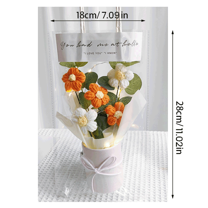 Knitted orange Daisy Serenity A bouquet of hand-knitted daisies a gift of peace and tranquility presented in a white bucket with a bow and clear gift bag